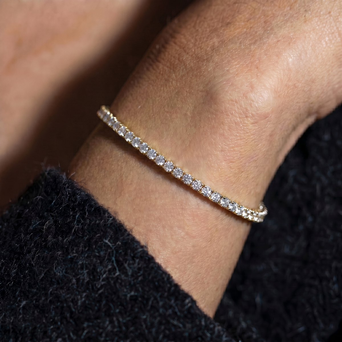 Close up su modella con bracciale tennis luminoso in finitura oro
